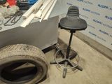 a tire sitting on the floor next to a bar stool