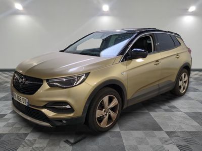 a gold opel suv parked on a checkered floor