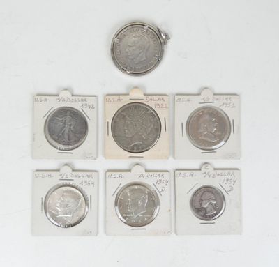 six different types of coins are in small packages on a white surface