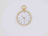 a gold pocket watch with roman numerals on the face