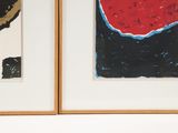 two paintings on the wall one is red and the other is black and white