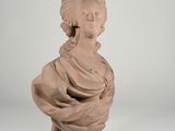 an image of a statue of a woman sitting on top of a table