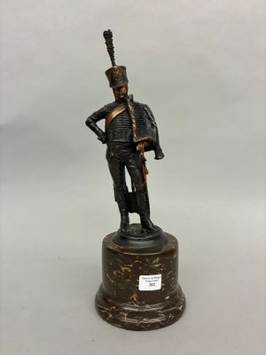 a bronze statue of a soldier with a sword on a pedestal