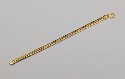 a close up of a gold chain on a white surface