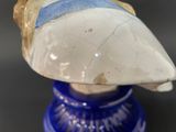 a blue vase with a white and blue bird on it
