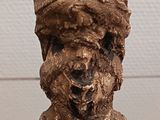 statue of a man with a hat on his head on a stand
