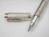 an image of a pen and a lighter sitting on a table