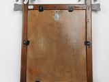 an old wooden mirror with metal handles and a wooden frame
