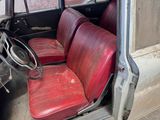 a red seat in the back of an old car