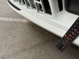 a measuring tape on the front of a white car