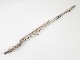 an old silver flute on a white surface with a white background