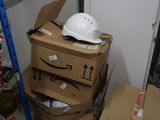 a pile of boxes and a hard hat on the floor