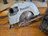 someone is using a circular saw to cut a piece of wood