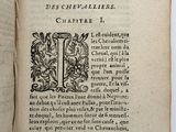 an open book with a black and white image of a cross on it