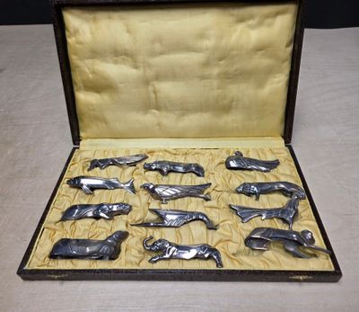 a lot of silver whale figurines in a case