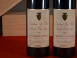 two bottles of wine sitting next to each other on a table