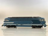 a blue and white train on a white surface