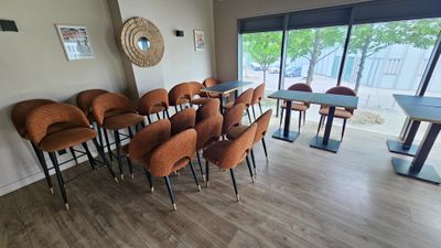 a room with a lot of chairs and tables in it