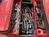 a red tool box filled with tools on a table