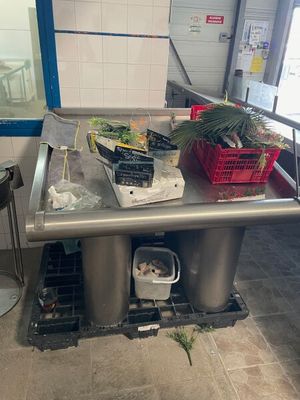 a table with a bunch of food on it in the kitchen