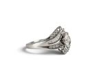 an image of a silver ring with a diamond center on a white background