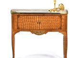 a small table with a drawer and a candle on it
