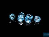 a group of three blue diamonds sitting on top of a black surface