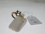 an image of a gold ring on a white surface with a price tag