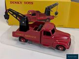 a red toy truck with a crane on the back of it