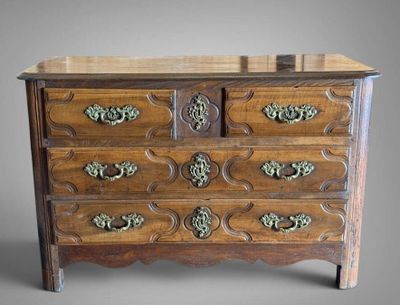 a wooden chest of drawers with brass hardware on the drawers