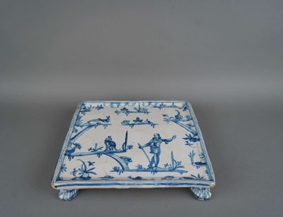 an old blue and white plate with birds and flowers on it