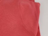 a close up of a pair of red sweaters on a white surface