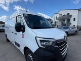 a white van parked in a parking lot next to a building