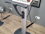an image of a room with a tread machine and a fan