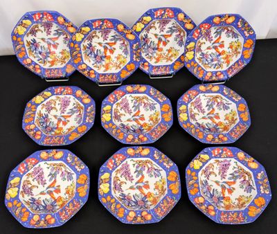 six blue and orange plates with floral designs on them on a table