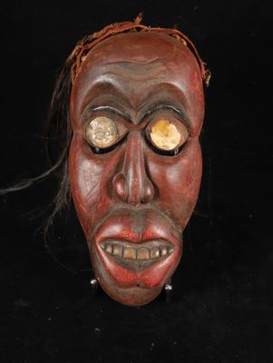 an image of a wooden mask on a black background