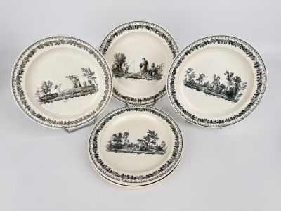 four black and white plates with a picture of people on them