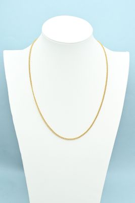 a gold chain necklace on a mannequin neck