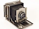 an old camera that is sitting on a white surface