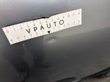someone is measuring the height of a car with a ruler