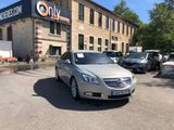 a silver car parked in front of a building with a sign on it