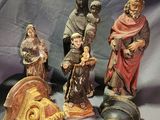 five figurines that are sitting on a blue cloth