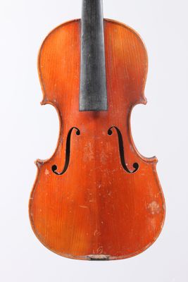 un vieux violon posé sur une surface blanche