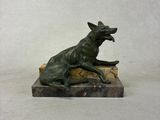 statue of a dog on a rock on a white background