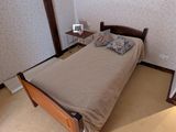 a small bed in a small room with a wallpapered wall