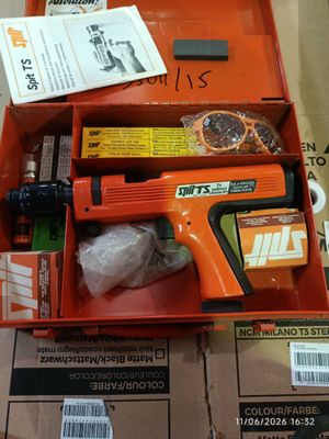 an orange box with a gun and other items in it