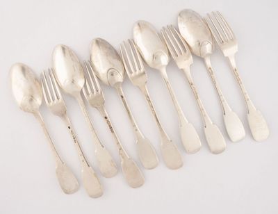 six silver spoons and a fork on a white surface