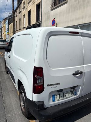 a white van that is parked on the side of the street