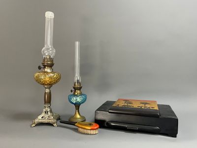 two candles, a book, and a candle holder on a table