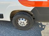 a white and orange bus parked on the side of the road